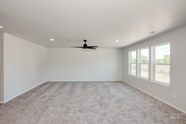 empty room with baseboards, light colored carpet, visible vents, and recessed lighting