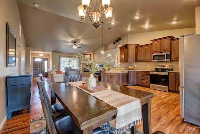 3623 E 3880 N, Kimberly, ID 83341 - dining room featuring vaulted ceiling, light wood-type flooring, a chandelier, and a ceiling fan