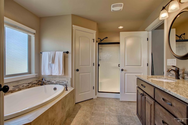 3623 E 3880 N, Kimberly, ID 83341 - full bathroom featuring vanity, a stall shower, and a garden tub