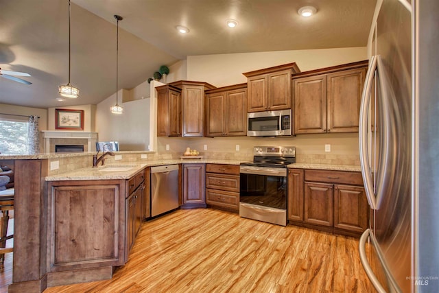 3623 E 3880 N, Kimberly, ID 83341 - kitchen with appliances with stainless steel finishes, lofted ceiling, a peninsula, brown cabinetry, and ceiling fan