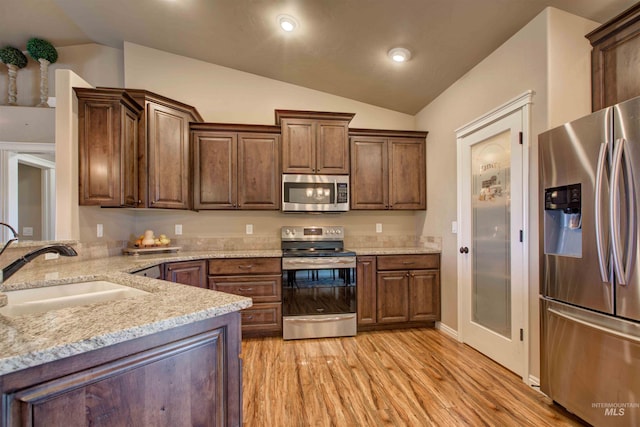 3623 E 3880 N, Kimberly, ID 83341 - kitchen featuring appliances with stainless steel finishes, lofted ceiling, light wood finished floors, light stone counters, and recessed lighting