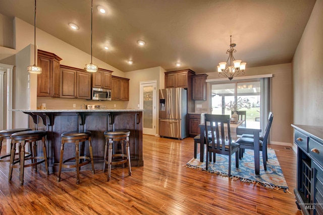 3623 E 3880 N, Kimberly, ID 83341 - kitchen with appliances with stainless steel finishes, wood finished floors, a chandelier, a peninsula, and lofted ceiling