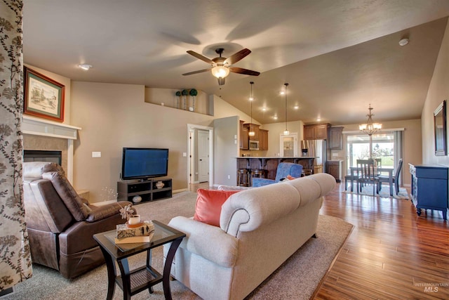 3623 E 3880 N, Kimberly, ID 83341 - living room featuring lofted ceiling, a ceiling fan, a chandelier, light wood-style flooring, and a fireplace