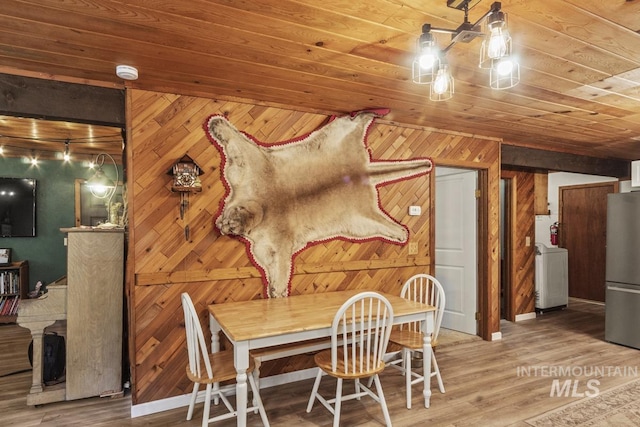 429 Doriann Dr, Cascade, ID 83611 - dining room featuring washer / dryer, wood finished floors, wood walls, and wooden ceiling