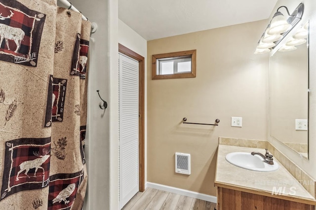 429 Doriann Dr, Cascade, ID 83611 - bathroom with vanity, a closet, wood finished floors, heating unit, and baseboards