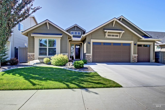 craftsman inspired home featuring a garage and a front yard