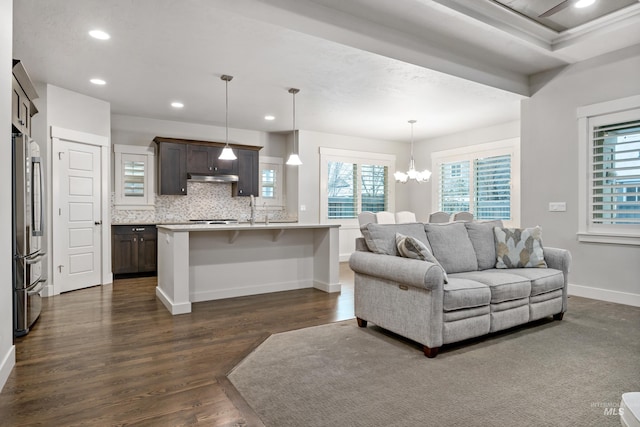 living room featuring a chandelier and dark hardwood / wood-style flooring