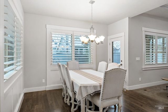 dining space featuring a chandelier and dark hardwood / wood-style floors