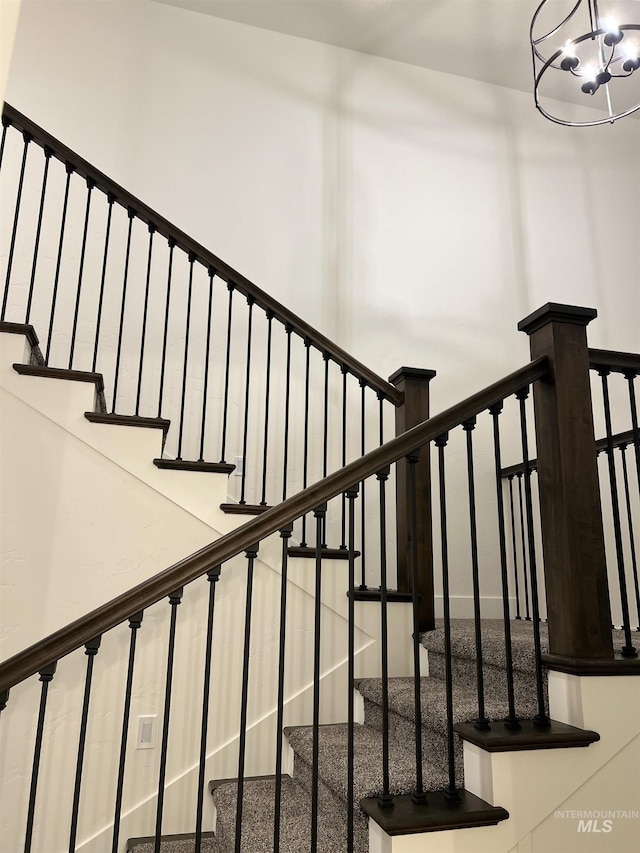 staircase featuring an inviting chandelier