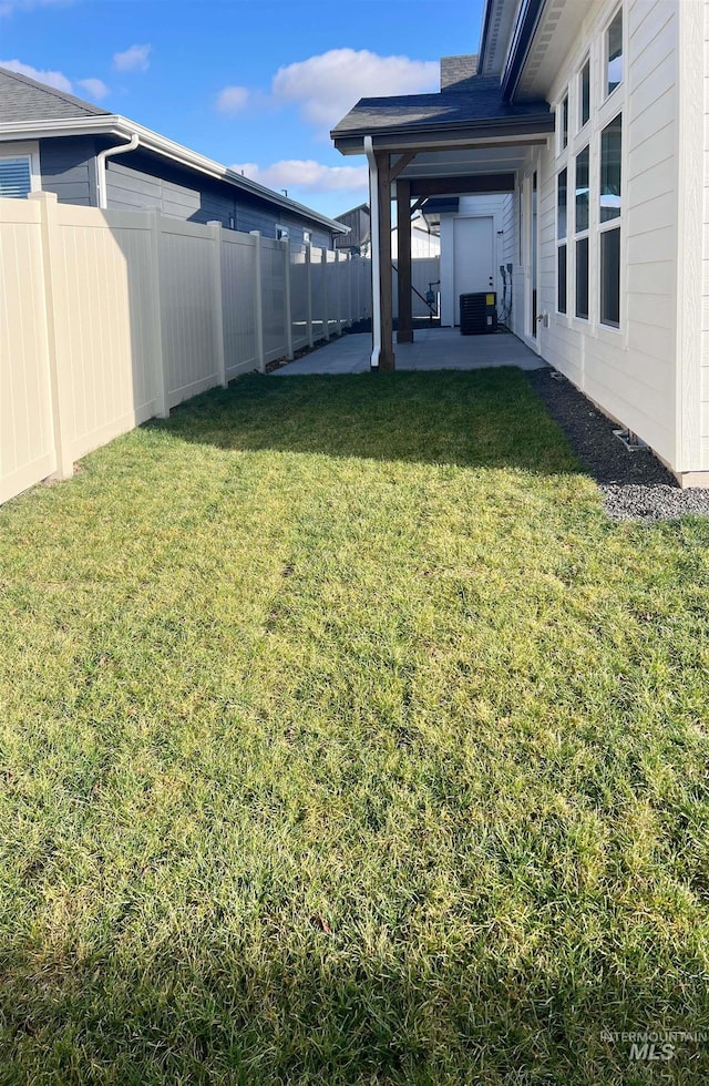 view of yard featuring central air condition unit, a patio area, and a fenced backyard