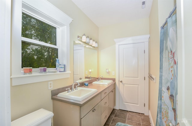 bathroom featuring tile patterned floors, vanity, and toilet