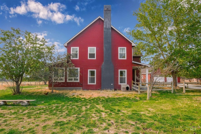 20169 Hoskins Rd, Caldwell, ID 83607 - back of house featuring a chimney, fence, ac unit, and a lawn