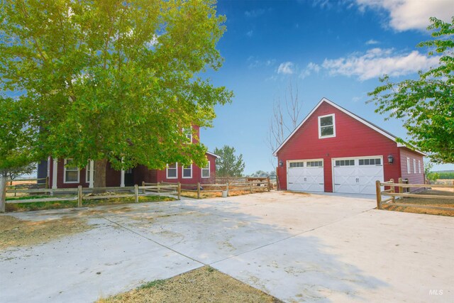 20169 Hoskins Rd, Caldwell, ID 83607 - view of side of property featuring fence, concrete driveway, an outdoor structure, and a garage