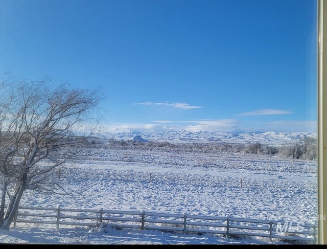 snowy yard featuring a mountain view