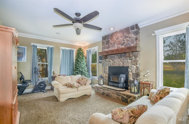 living room with carpet floors, crown molding, ceiling fan, and a wood stove