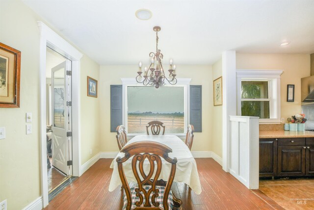 20169 Hoskins Rd, Caldwell, ID 83607 - dining area with light wood-style floors, a healthy amount of sunlight, and a notable chandelier