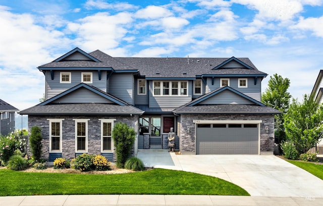 craftsman house featuring a garage, concrete driveway, stone siding, roof with shingles, and a front yard