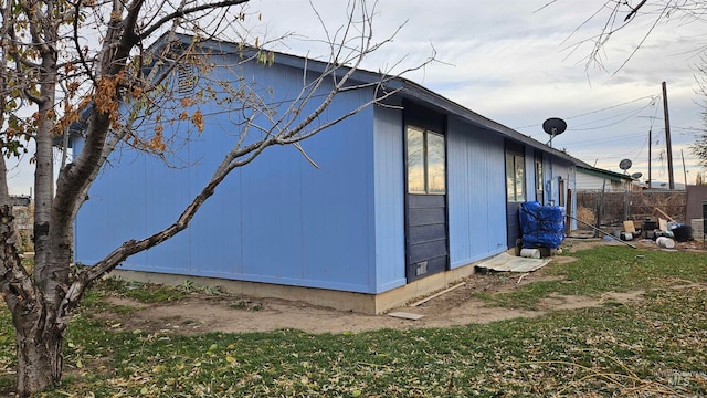 view of side of home with a lawn