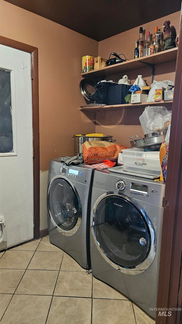 laundry area featuring separate washer and dryer and light tile patterned flooring