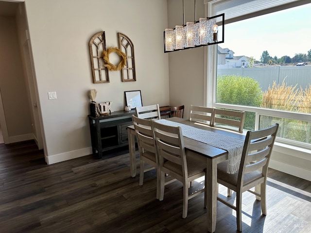 dining area featuring dark wood-type flooring and a chandelier