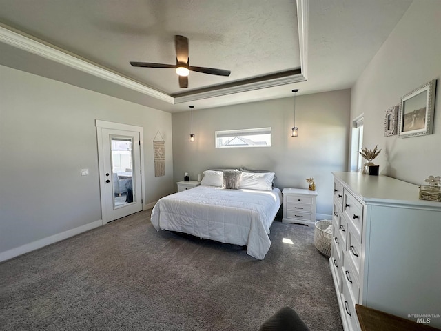 carpeted bedroom with access to exterior, a tray ceiling, and ceiling fan