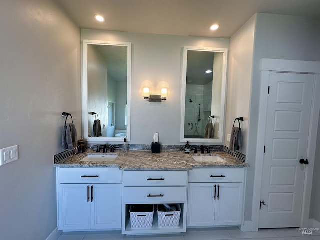 bathroom with tile patterned floors, vanity, toilet, and walk in shower