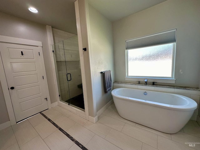 bathroom featuring tile patterned floors and plus walk in shower