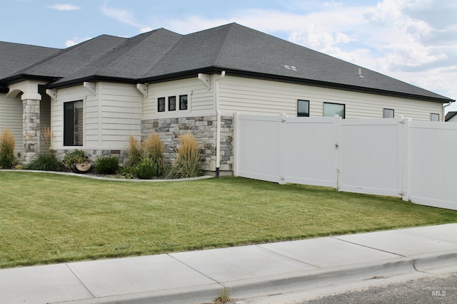 view of home's exterior with a yard