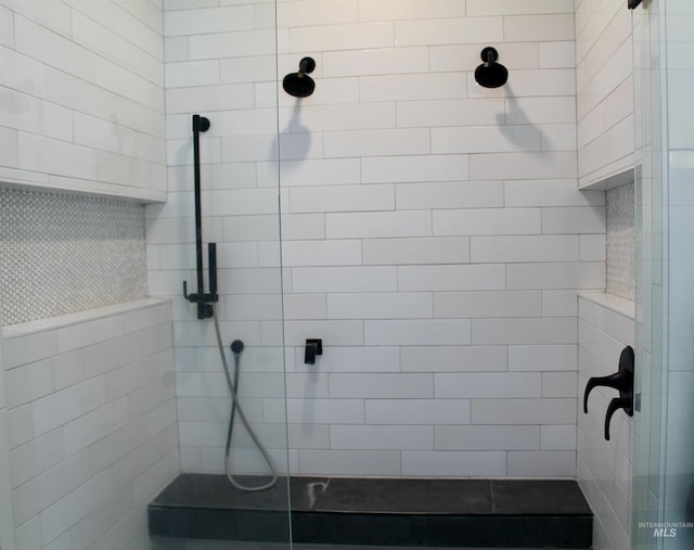 bathroom with tiled shower