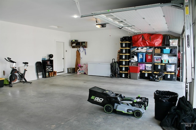 garage with a garage door opener and fridge