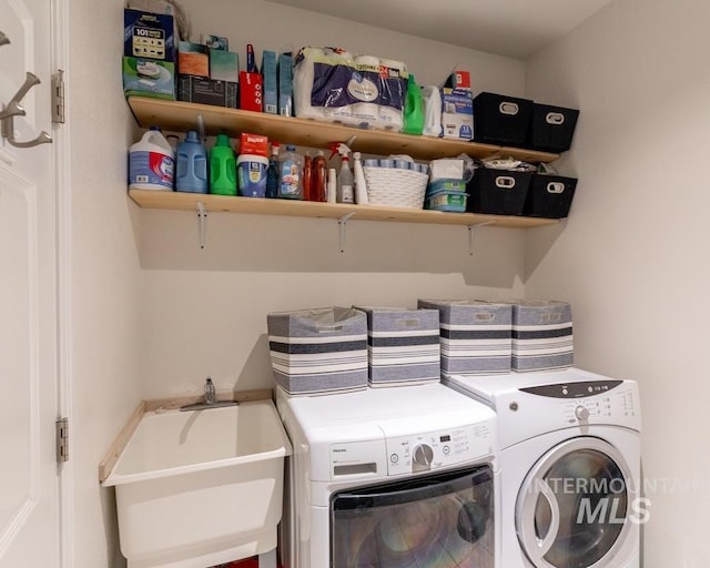 laundry room featuring separate washer and dryer, laundry area, and a sink
