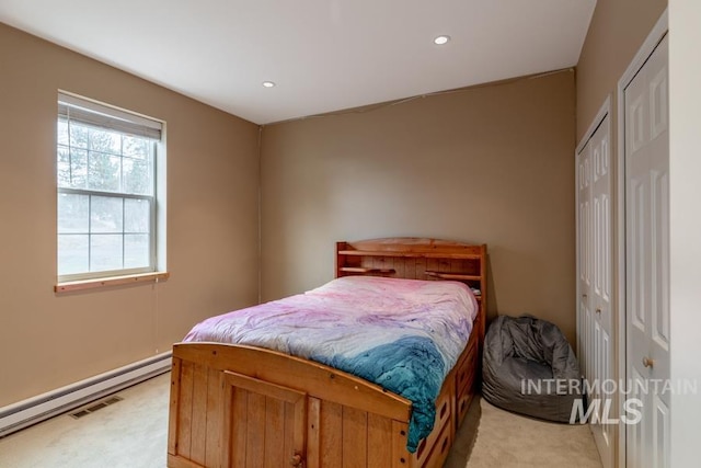 bedroom with visible vents, recessed lighting, baseboard heating, and light colored carpet