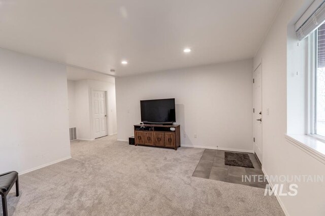 carpeted living room with baseboards, visible vents, and recessed lighting