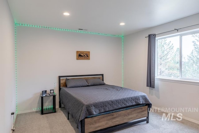 bedroom with baseboards, recessed lighting, and carpet flooring