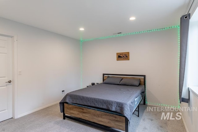 carpeted bedroom featuring baseboards, visible vents, and recessed lighting