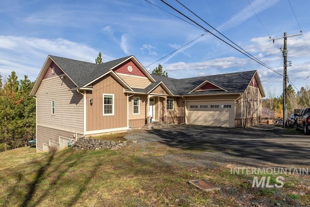 view of front of property with board and batten siding, a front yard, driveway, and an attached garage