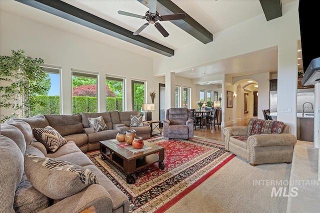 1480 N Colline Bello, Eagle, ID 83616 - living room with arched walkways, beamed ceiling, and a ceiling fan