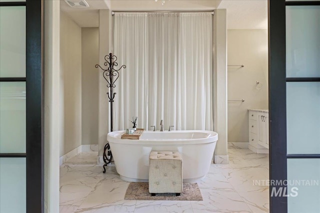1480 N Colline Bello, Eagle, ID 83616 - full bath with marble finish floors, a soaking tub, and baseboards