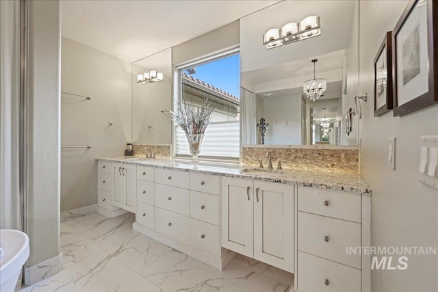 1480 N Colline Bello, Eagle, ID 83616 - bathroom with a chandelier, marble look tiles, and double vanity