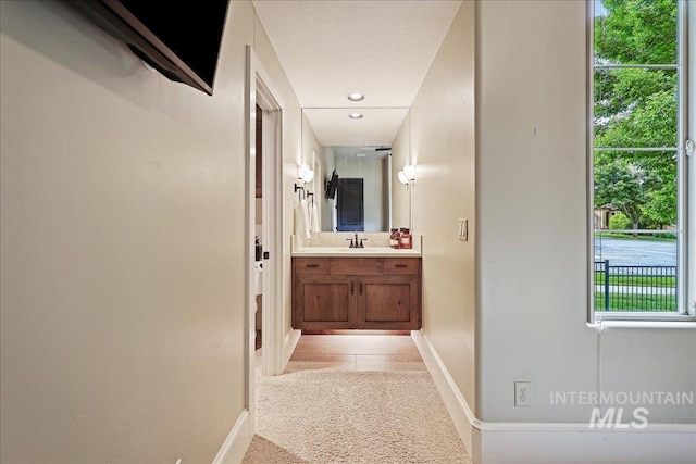 1480 N Colline Bello, Eagle, ID 83616 - hallway featuring a sink, light colored carpet, and baseboards