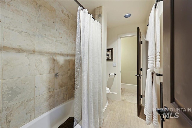 1480 N Colline Bello, Eagle, ID 83616 - bathroom featuring shower / bath combination with curtain, wood finished floors, baseboards, and toilet
