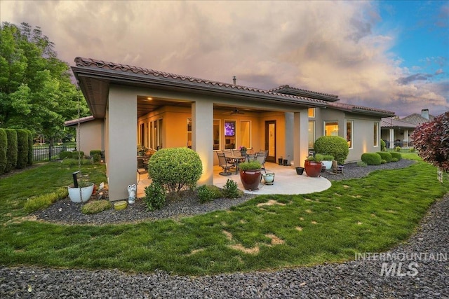 1480 N Colline Bello, Eagle, ID 83616 - back of property with stucco siding, a patio, a ceiling fan, and a tiled roof