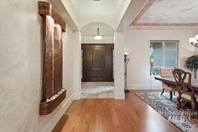 1480 N Colline Bello, Eagle, ID 83616 - foyer entrance with baseboards, light wood finished floors, and arched walkways