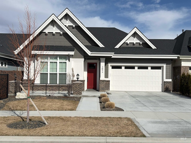 craftsman house with a garage, concrete driveway, and brick siding