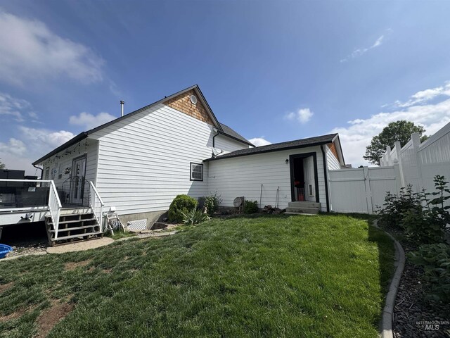 1128 30th St, Lewiston, ID 83501 - back of property featuring a wooden deck and entry steps