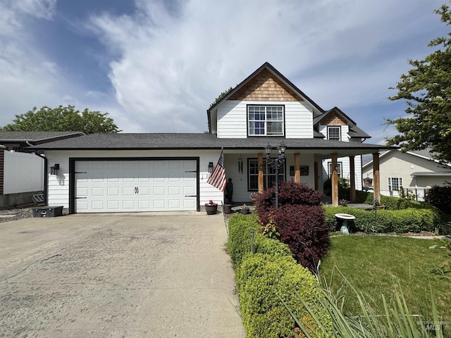 1128 30th St, Lewiston, ID 83501 - view of front of home featuring driveway, a garage, covered porch, and a shingled roof