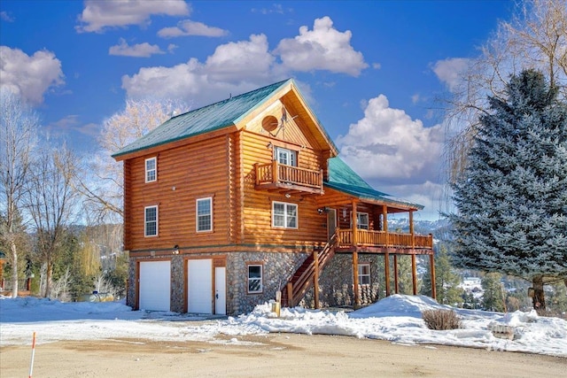 view of front of home featuring a garage and a balcony