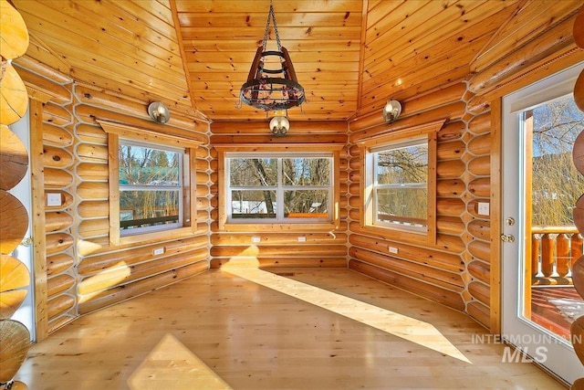 unfurnished sunroom featuring vaulted ceiling