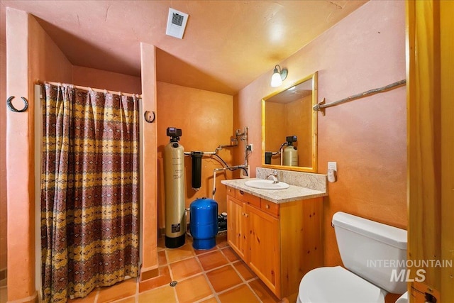 bathroom with vanity, curtained shower, toilet, and tile patterned flooring