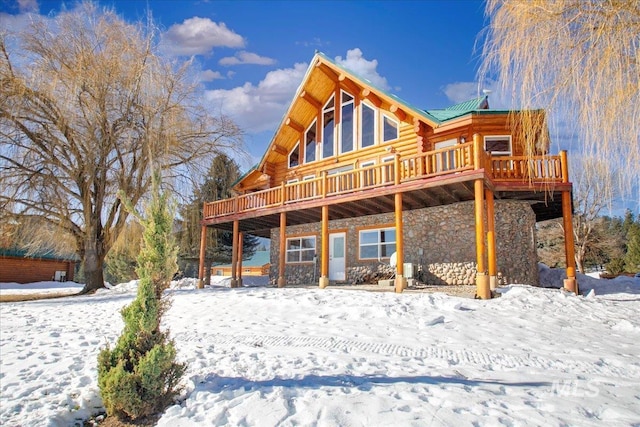 snow covered property featuring a deck